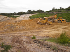 Long distance shot of machinery preparing the site