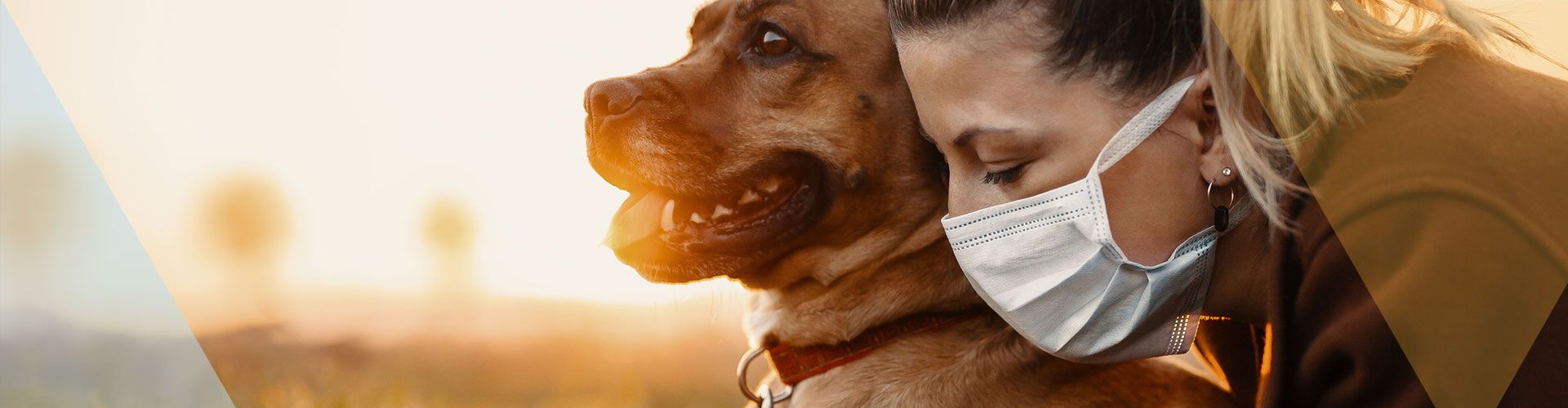 Picture of a woman wearing a face mask with her dog.