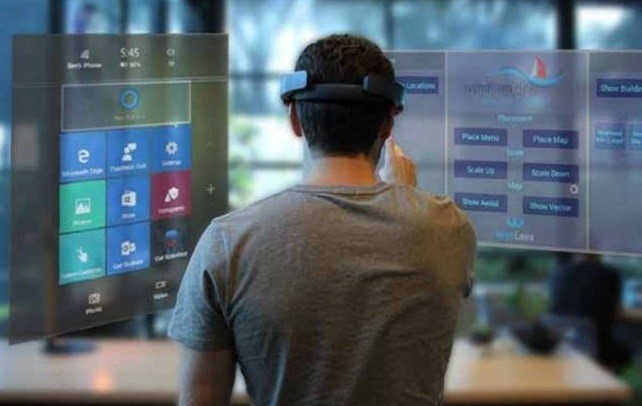 Man wearing HoloLens interacting with virtual environment 
